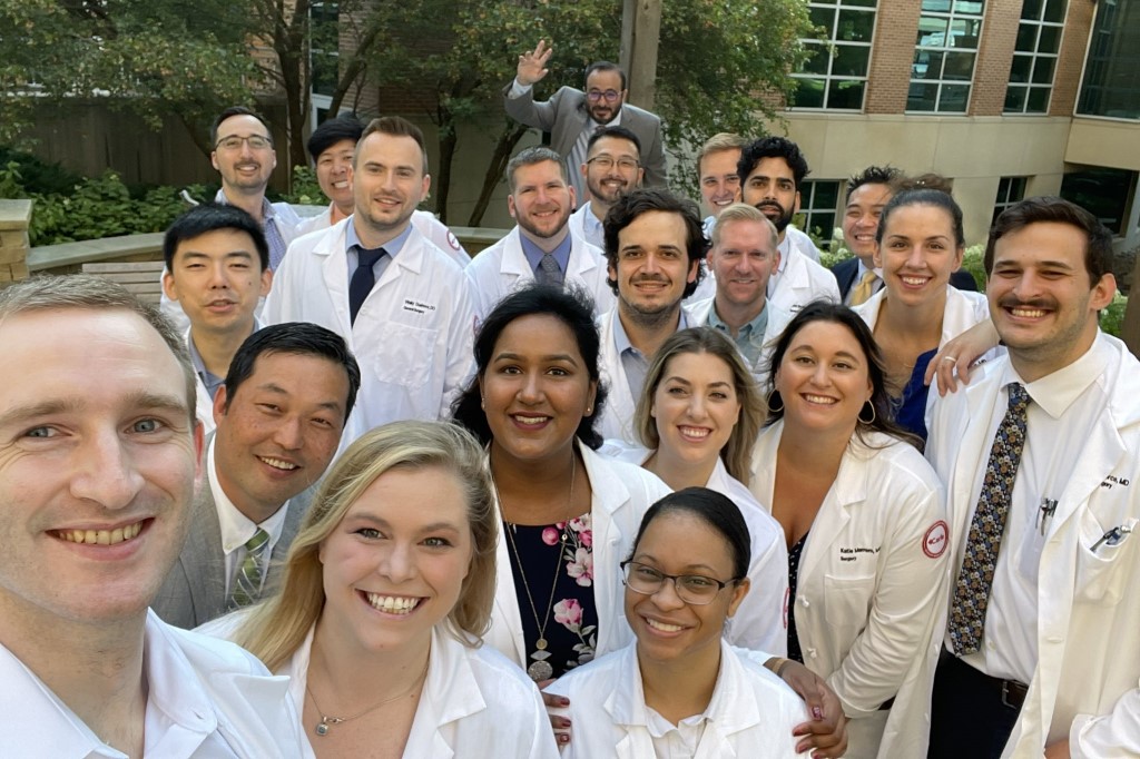 General surgery residents and faculty posing for a picture outdoors.